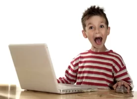 happy-kid-at-computer.webp